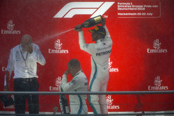 Race winner Lewis Hamilton, Mercedes AMG F1, second place Valtteri Bottas, Mercedes AMG F1, and Dr Dieter Zetsche, CEO, Mercedes Benz, celebrate with Champagne on the podium