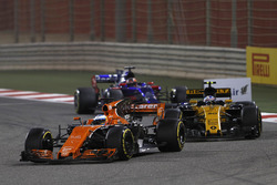Fernando Alonso, McLaren MCL32, leads Jolyon Palmer, Renault Sport F1 Team RS17, and Daniil Kvyat, Scuderia Toro Rosso STR12
