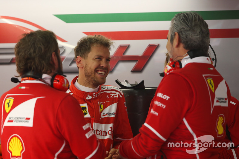 Sebastian Vettel, Ferrari, talks to Maurizio Arrivabene, Team Principal, Ferrari and a team mate