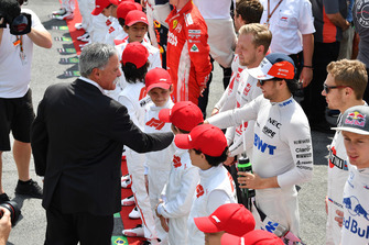 Chase Carey, Chief Executive Officer and Executive Chairman of the Formula One Group and Sergio Perez, Racing Point Force India on the grid