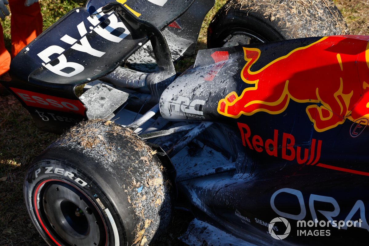 The car of Max Verstappen, Red Bull Racing RB18, with fire retardant after retirement and a fire