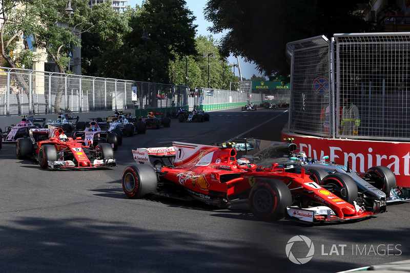 Kimi Raikkonen, Ferrari SF70H battles, Valtteri Bottas, Mercedes AMG F1 F1 W08 for position and collide at the start of the race