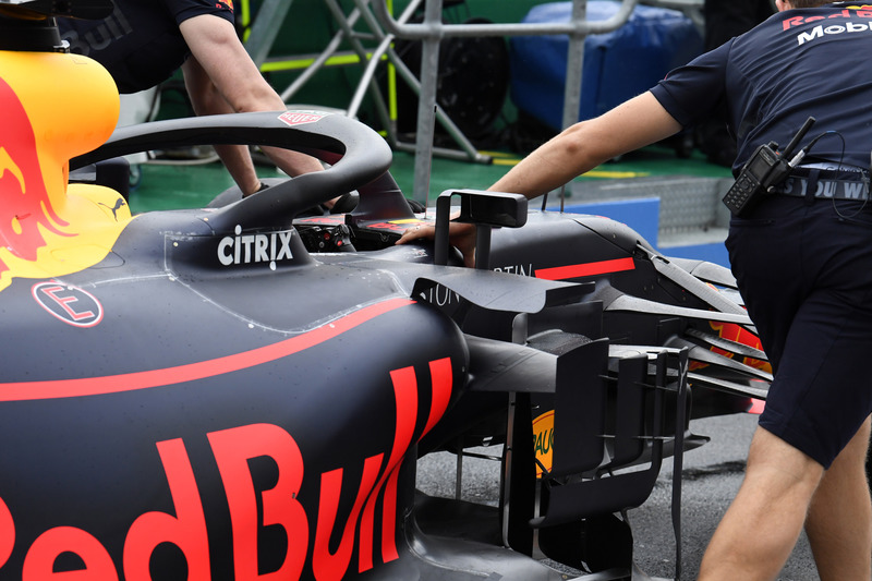 Red Bull Racing mechanics push Red Bull Racing RB14 in pit lane