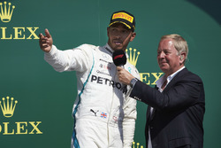 Lewis Hamilton, Mercedes AMG F1, is interviewed by Martin Brundle, on the podium