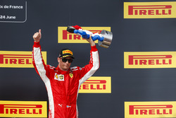Kimi Raikkonen, Ferrari, 3rd position, with his trophy on the podium
