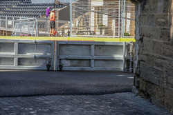 The new aspahlt for the circuit and the old cobble stone pavement