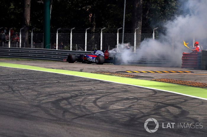 Mariscal agita la bandera amarilla debido a que Carlos Sainz Jr., Scuderia Toro Rosso STR12 se detiene en la pista