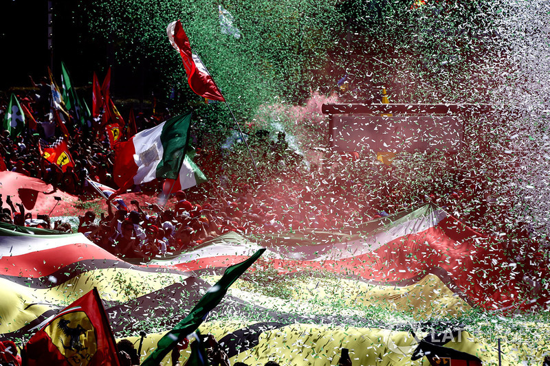 Confetti falls around the huge crowd of Ferrari fans gathered for the podium ceremony