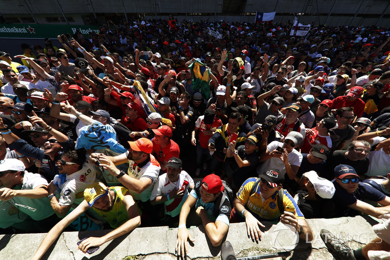 Fans gather at the podium after the race