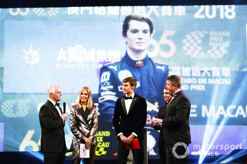 Williams F1 Driver George Russell, and McLaren F1 driver Lando Norris on stage to present the National Racing Driver Award to Dan Ticktum, accepted on his behalf by Derek Warwick