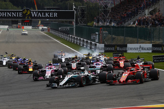 Lewis Hamilton, Mercedes AMG F1 W09, leads Sebastian Vettel, Ferrari SF71H, Sergio Perez, Racing Point Force India VJM11, Esteban Ocon, Racing Point Force India VJM11, Romain Grosjean, Haas F1 Team VF-18, and the rest of the field at the start. Nico Hulkenberg, Renault Sport F1 Team R.S. 18. locks-up in the background