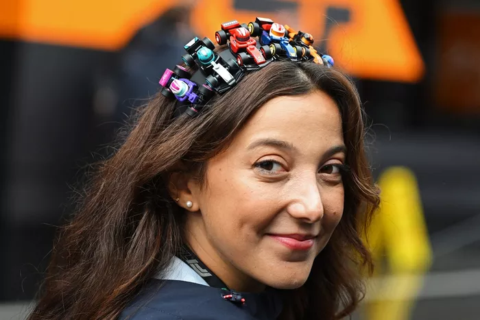 A fan wears a headband made of LEGO F1 cars
