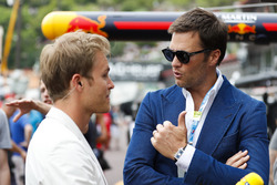 NFL player Tom Brady talks to Nico Rosberg