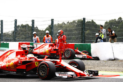 Sebastian Vettel, Ferrari SF70H, passes Kimi Raikkonen, Ferrari SF70H, as he climbs from his car after crashing