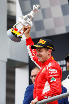 Sebastian Vettel, Ferrari celebrates on the podium with the trophy