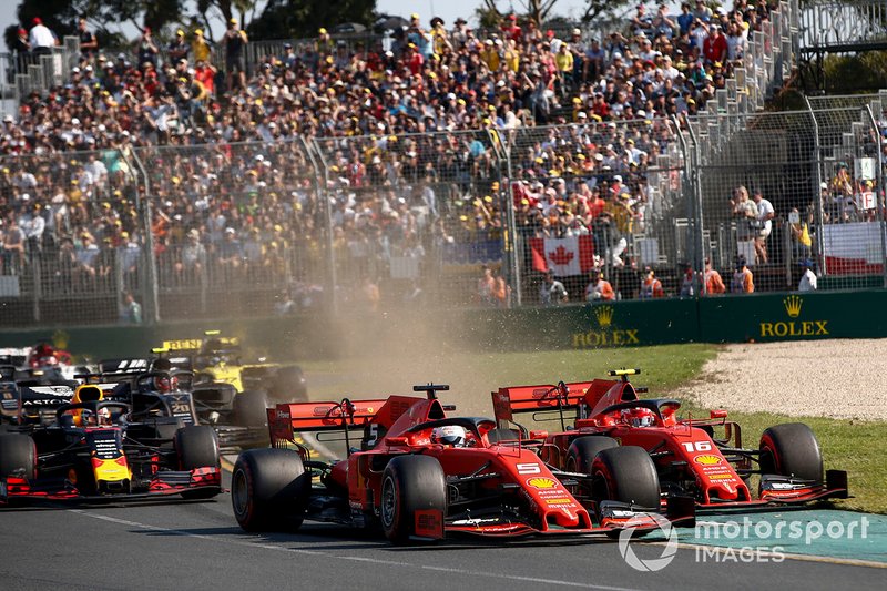 Sebastian Vettel, Ferrari SF90, leads Charles Leclerc, Ferrari SF90 and the rest of the field at the start