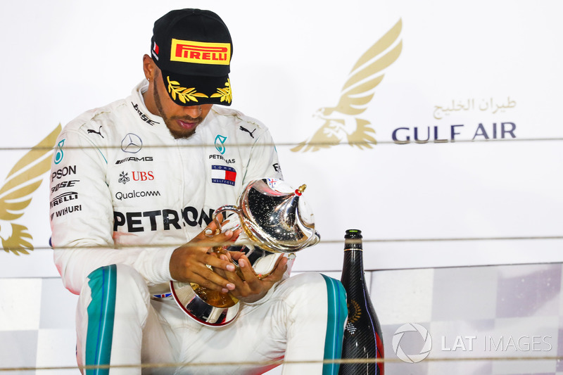 Lewis Hamilton, Mercedes AMG F1, 3rd position, inspects his trophy on the podium