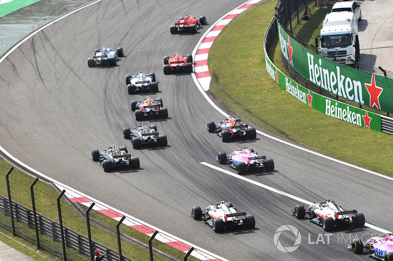 Sebastian Vettel, Ferrari SF71H and Kimi Raikkonen, Ferrari SF71H lead at the start of the race