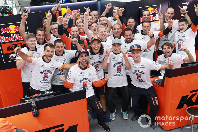 Miguel Oliveira, Can Oncu, and Red Bull KTM Ajo team members celebrate