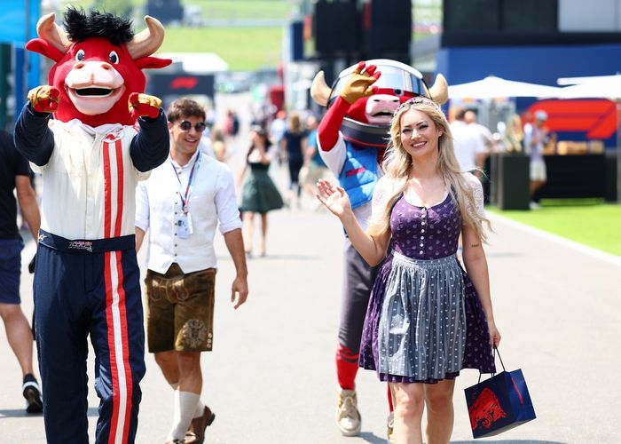 The Red Bull mascot with a lady wearing traditional a dirndl dress