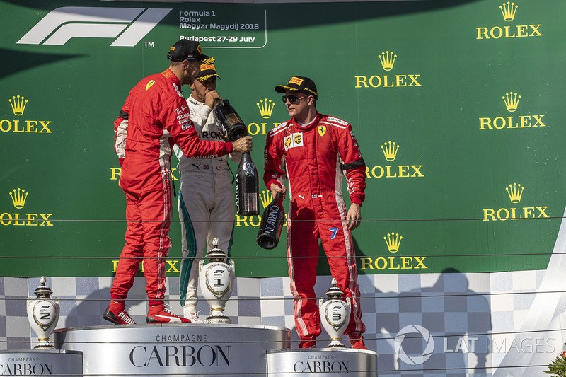 Sebastian Vettel, Ferrari, Lewis Hamilton, Mercedes-AMG F1 and Kimi Raikkonen, Ferrari celebrate on the podium with the champagne