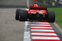 Sebastian Vettel, Ferrari SF71H, strikes up sparks over a kerb