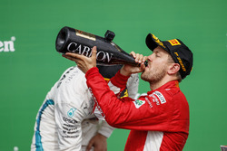 Sebastian Vettel, Ferrari, 1st position, drinks Champagne on the podium