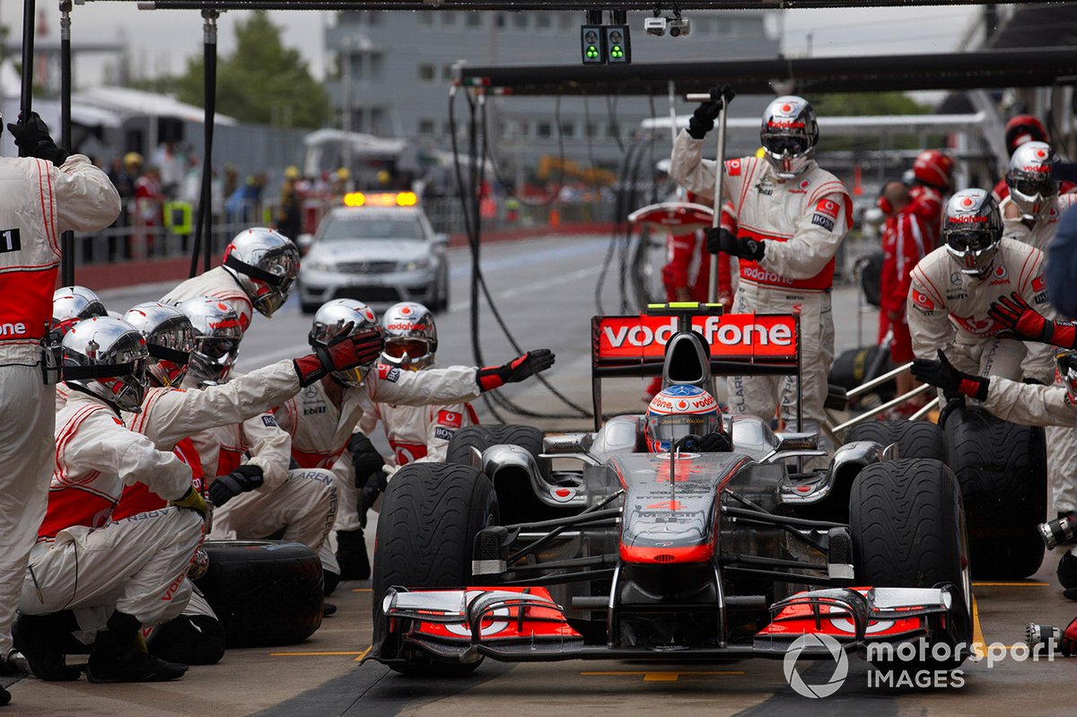 Jenson Button, McLaren MP4-26 Mercedes, leaves the pits after making a pit stop for a new front wing