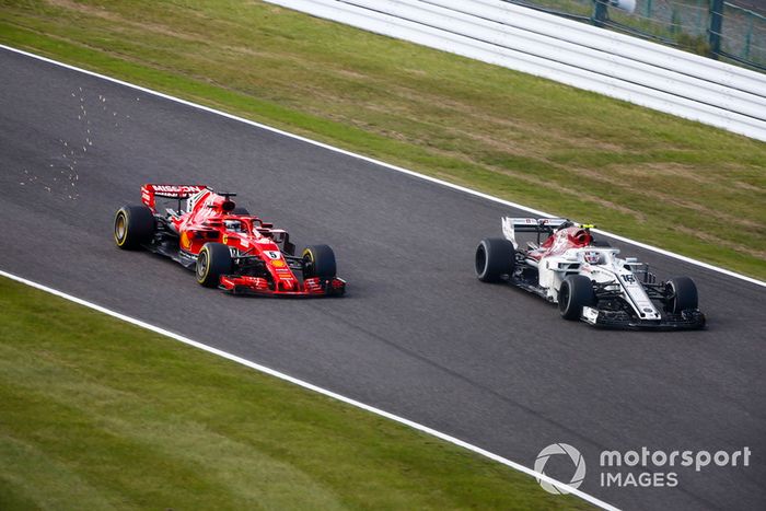 Sebastian Vettel, Ferrari SF71H, passes Charles Leclerc, Sauber C37