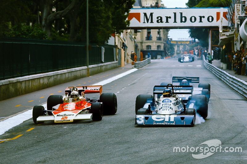 Jochen Mass, McLaren M23 Ford, overtakes Ronnie Peterson, Tyrrell P34 Ford, with Mario Andretti, Lotus 78 Ford, in pursuit