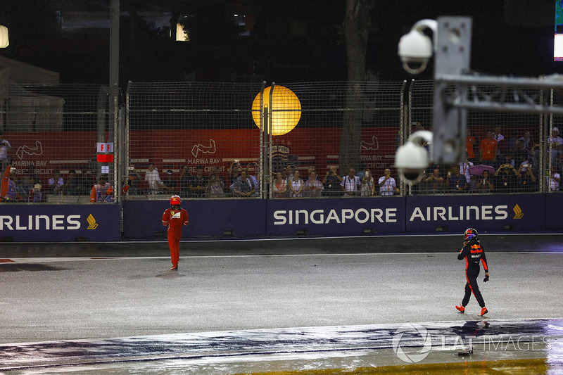 Kimi Raikkonen, Ferrari and Max Verstappen, Red Bull Racing walk back to the pits after their collis