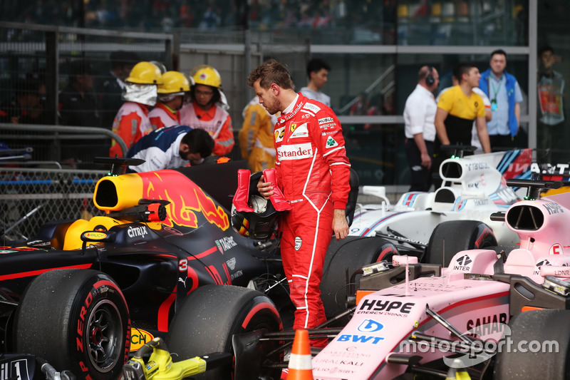 Sebastian Vettel, Ferrari, inspects the car of Daniel Ricciardo, Red Bull Racing RB13, in Parc Ferme after Qualifying