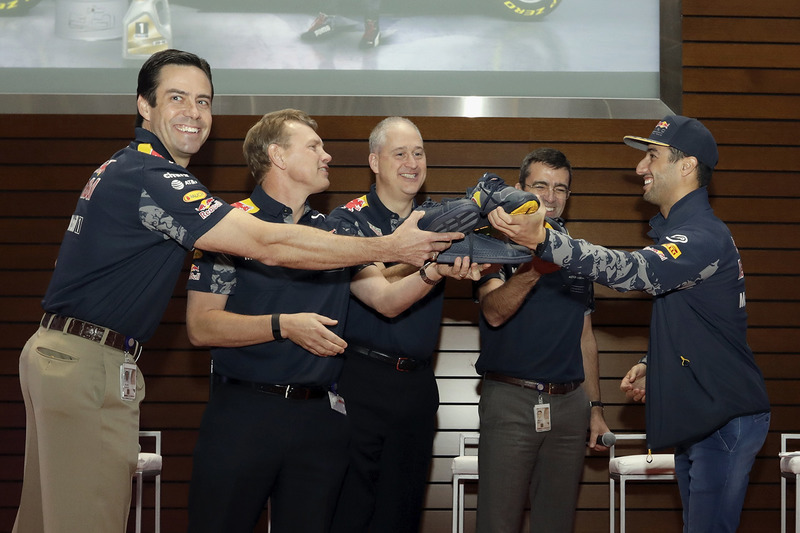 Daniel Ricciardo, Red Bull Racing prepares to drink champagne from shoes with VIPs at the ExxonMobil headquarters