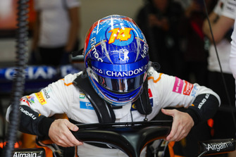 Fernando Alonso, McLaren, lowers himself into his seat