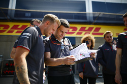 Kevin Magnussen, Haas F1 Team, views a document with engineer Guiliano Salvi