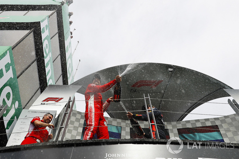 Sebastian Vettel, Ferrari, 1st position, sprays Champagne from the podium
