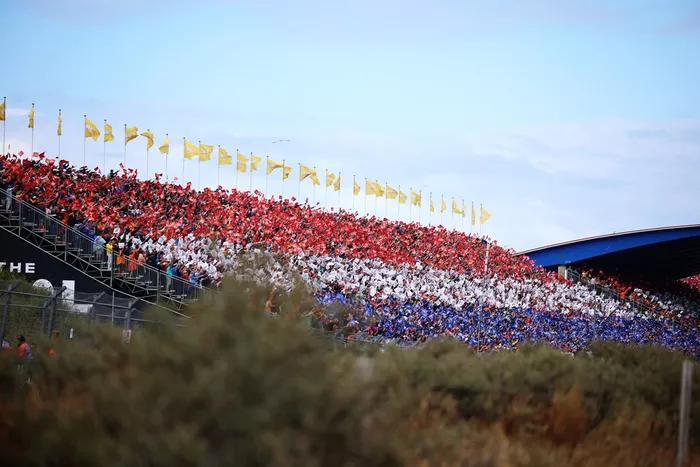 Fans form the Dutch flag colours