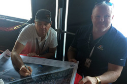 Jimmy Vasser and Paul Tracy sign Justin Wilson poster