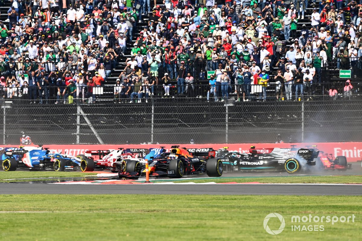 Max Verstappen, Red Bull Racing RB16B, as Valtteri Bottas, Mercedes W12, spins on the opening lap