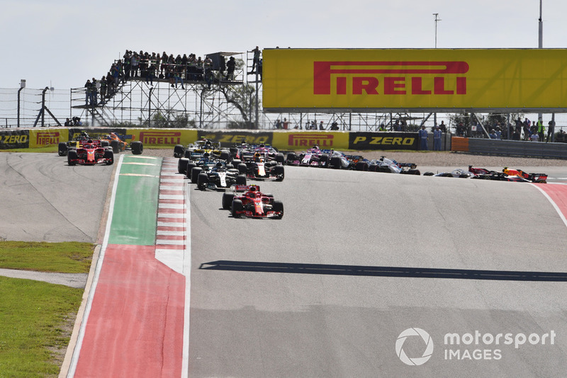Kimi Raikkonen, Ferrari SF71H and Lewis Hamilton, Mercedes-AMG F1 W09 leads at the start of the race