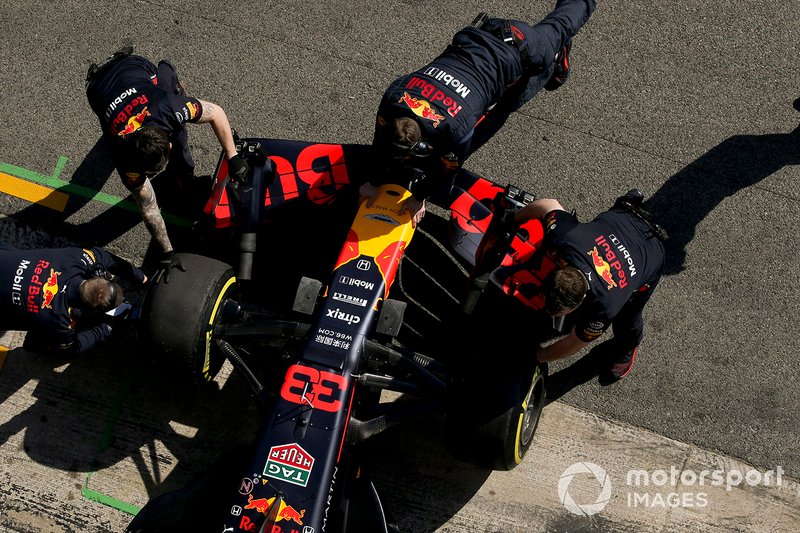 Max Verstappen, Red Bull Racing, is attended to by mechanics in the pit lane