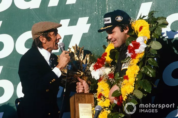 Alan Jones, Williams, interviewed on the podium by Jackie Stewart, with Carlos Reutemann, Williams
