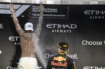 Lewis Hamilton, Mercedes AMG F1 and Max Verstappen, Red Bull Racing celebrate on the podium with the champagne