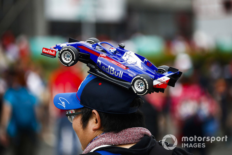 A fan with a Toro Rosso model car hat