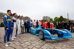 Drivers pose with the iceberg livery on a Formula E car that will be auctioned off to raise money to fight climate change