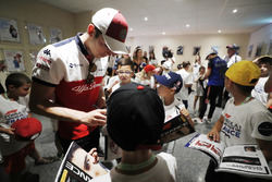 Charles Leclerc, Sauber, signs autographs for the grid kids