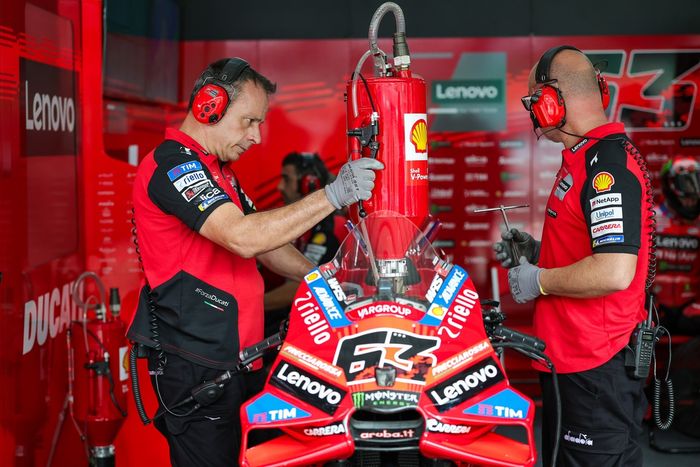 Two Ducati Team Mechanics refuels the bike