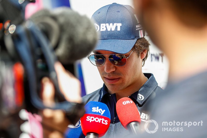 Lance Stroll, Racing Point, talks to the press