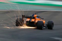 Sparks fly from the car of Fernando Alonso, McLaren MCL33 Renault