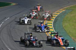 Jenson Button, McLaren MP4-31 and Pascal Wehrlein, Manor Racing MRT05